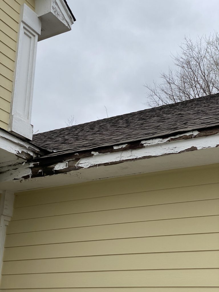 Rotting soffit from not having gutters installed. MJT Roofing gutter installation in Willimantic, CT